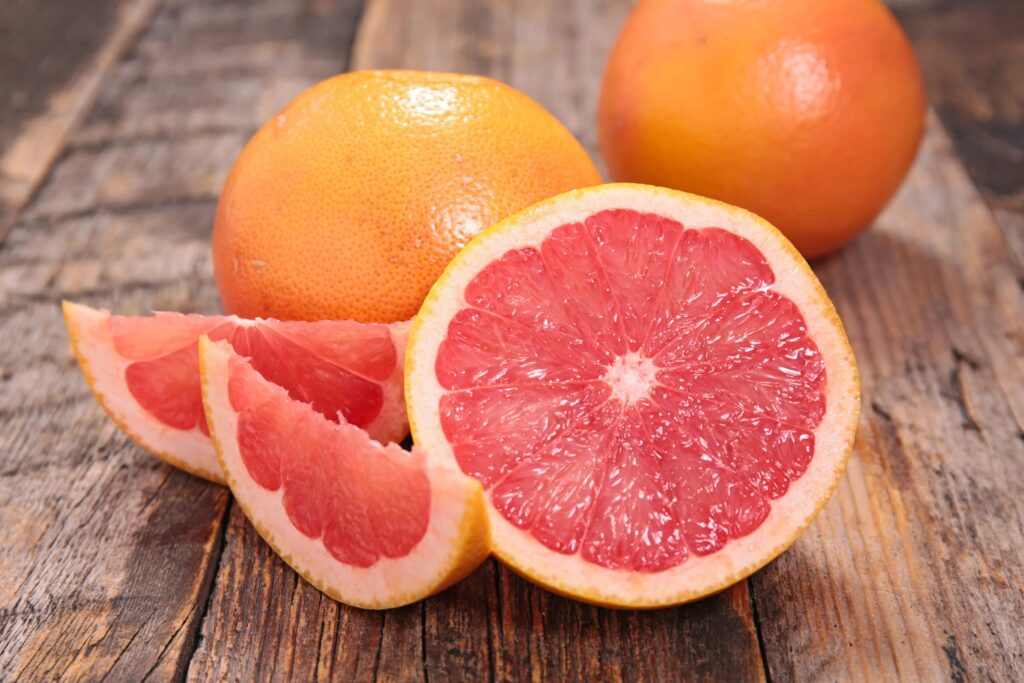 Pink grapefruit fruits, one cut open